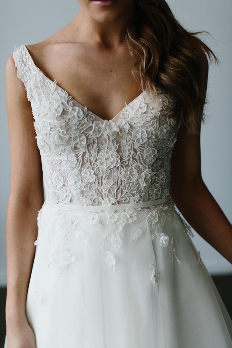 The Lydia gown by Karen Willis Holmes, blush v-neck a-line lace wedding dress with lace appliqué.