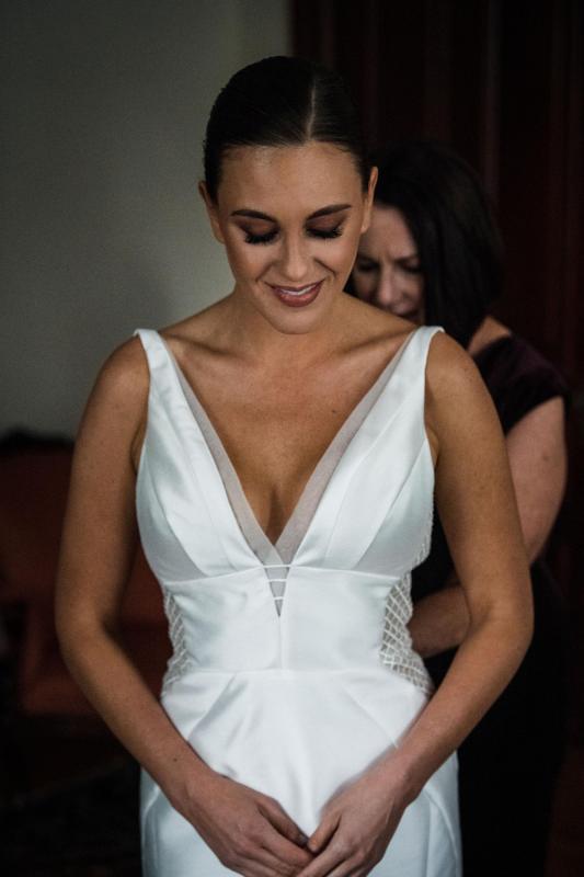 Real bride Caitlin wore the Bespoke Shelly/Samantha wedding dress by Karen Willis Holmes.