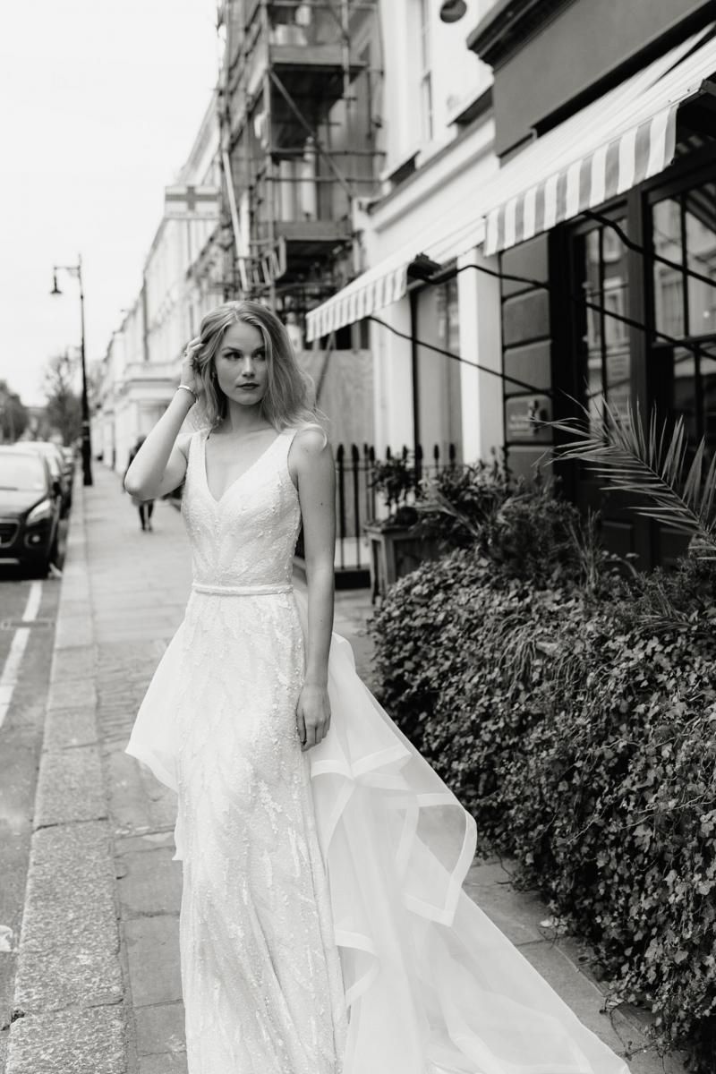 The Rhiannon gown by Karen Willis Holmes, fit and flare v-neck wedding dress shown with detachable train.