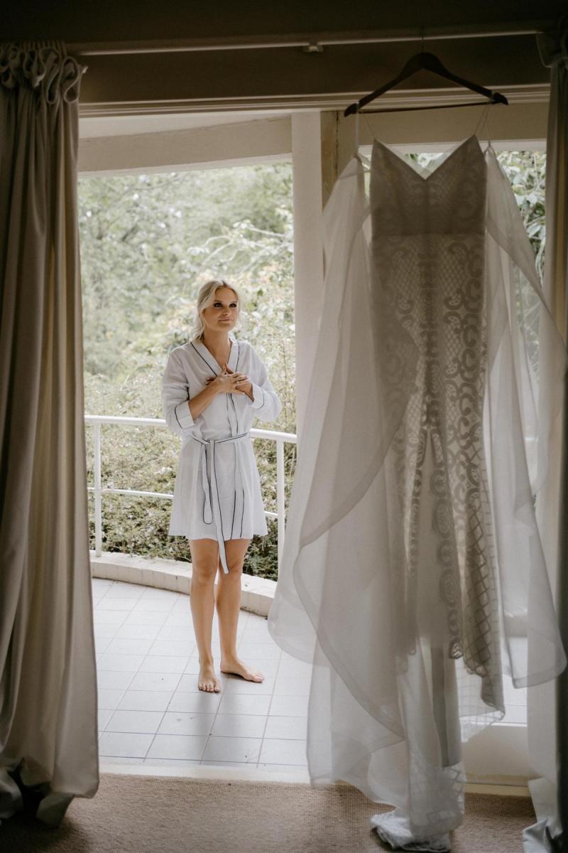 Elodie wedding dress by Karen Willis Holmes hanging up morning of wedding with elated bride