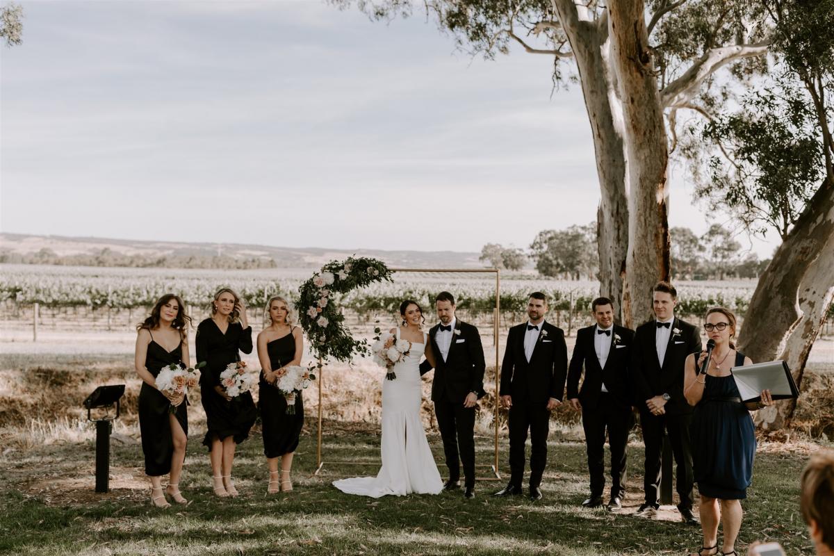 KWH real bride Rachael and husband Adam and their wedding party. Rachael wears the Violet gown.