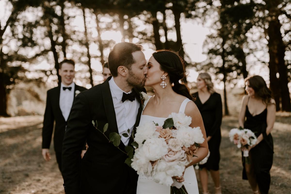 KWH bride Rachael and Adam sharing a kiss. Rachael wears the timeless Violet gown.