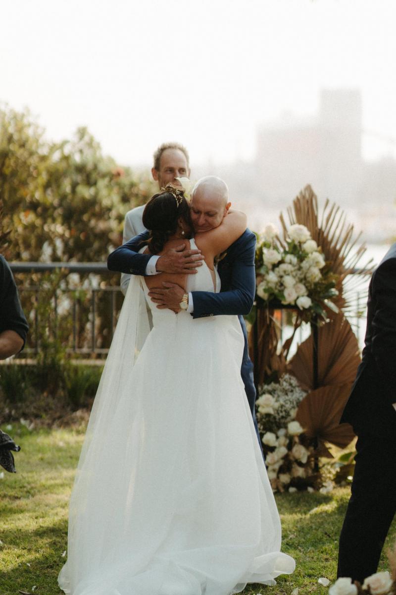 Bride and groom in Sydney Harbour, bride wearing AISHA gown by Karen Willis Holmes; a modern Bespoke wedding dress