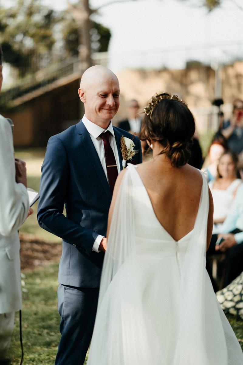 Bride and groom at Sydney wedding ceremony; bride wearing Aisha gown by Karen Willis Holmes