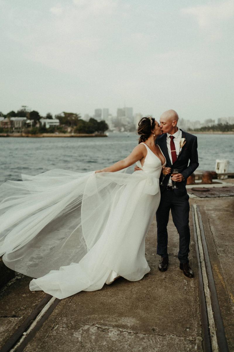 Bride and groom in Sydney Harbour, bride wearing AISHA gown by Karen Willis Holmes; a modern Bespoke wedding dress
