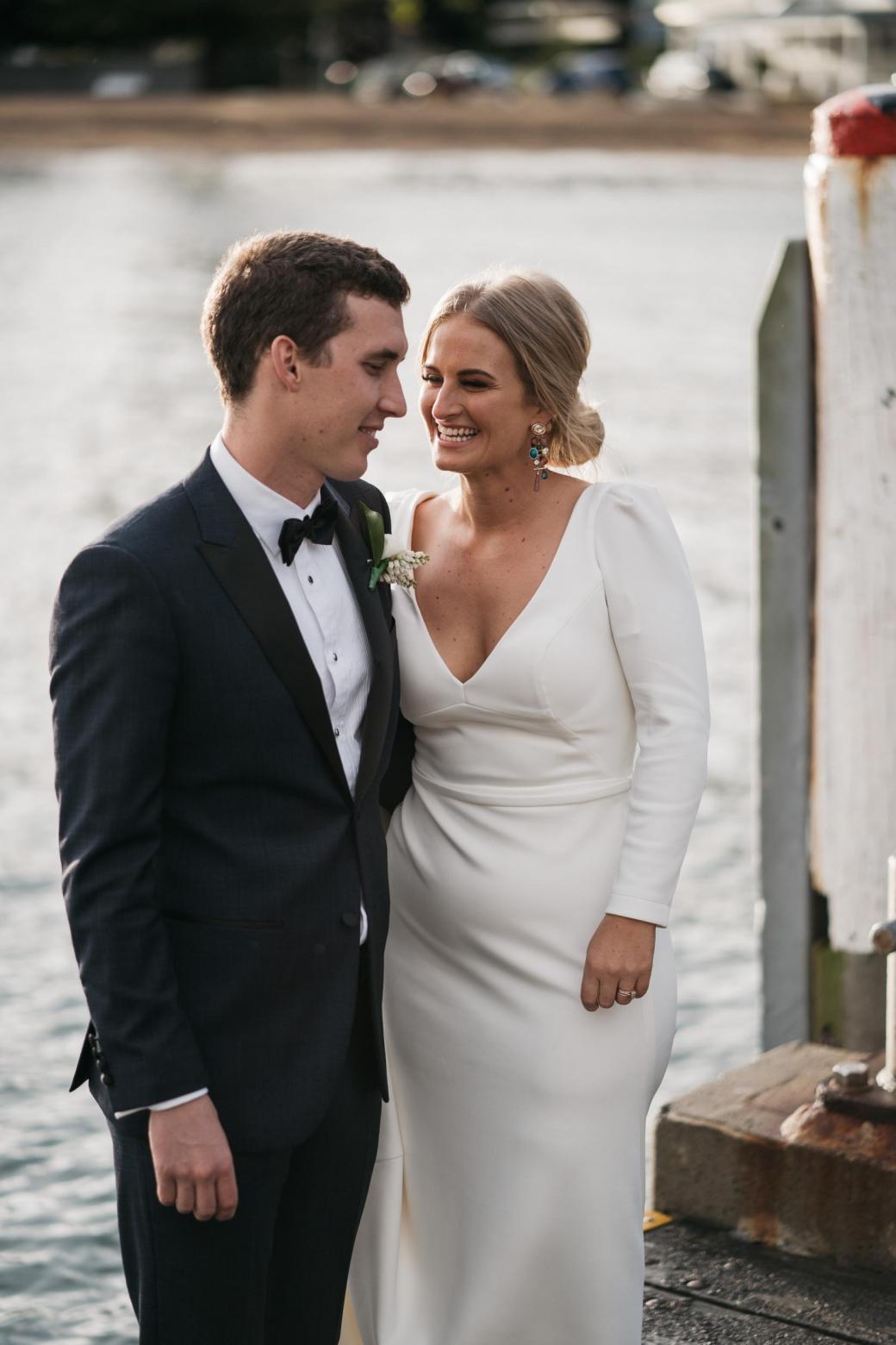 KWH bride Jordana with her new husband; wearing the AUBREY gown; a timeless long-sleeve wedding dress.