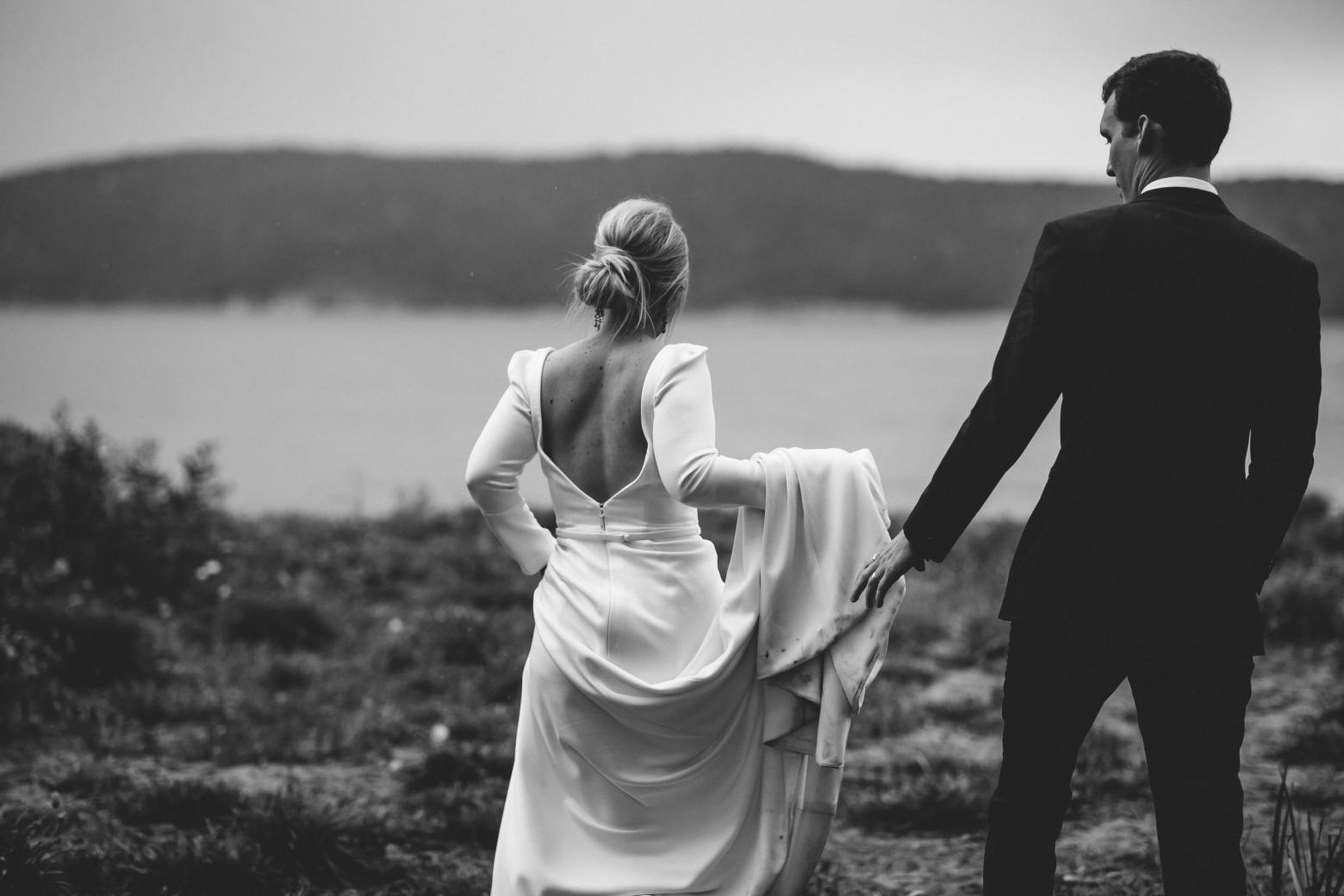 B&W image of KWH bride Jordana and husband Mitch; bride wearing the AUBREY gown with a low back and long train.