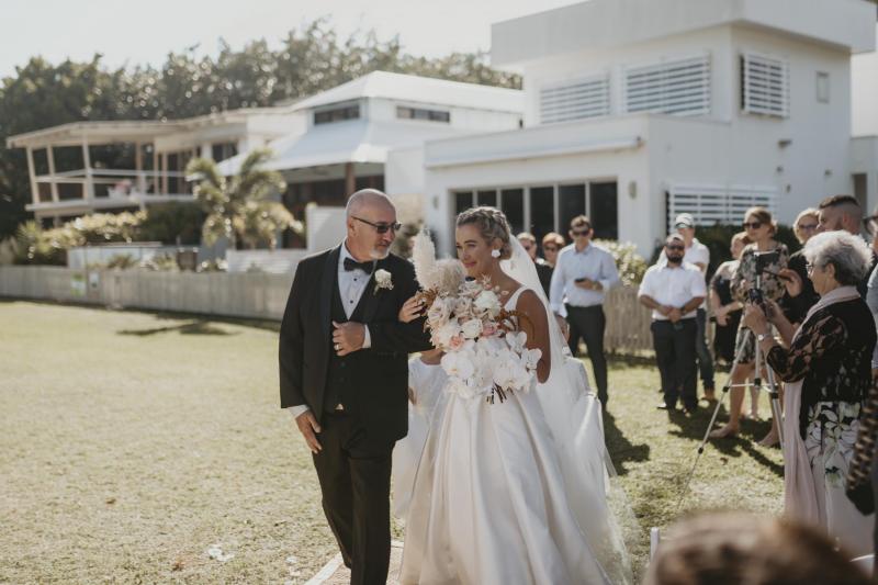 Kelsi wears the Leonie Melanie gown; a V-neck, A-line, simple wedding dress, for her Queensland wedding