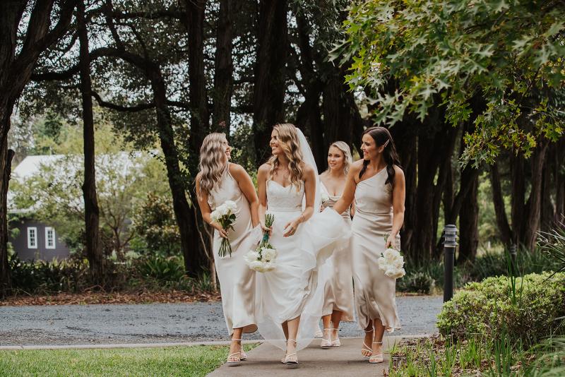 Bride and her bridesmaid's walking to ceremony in KWH