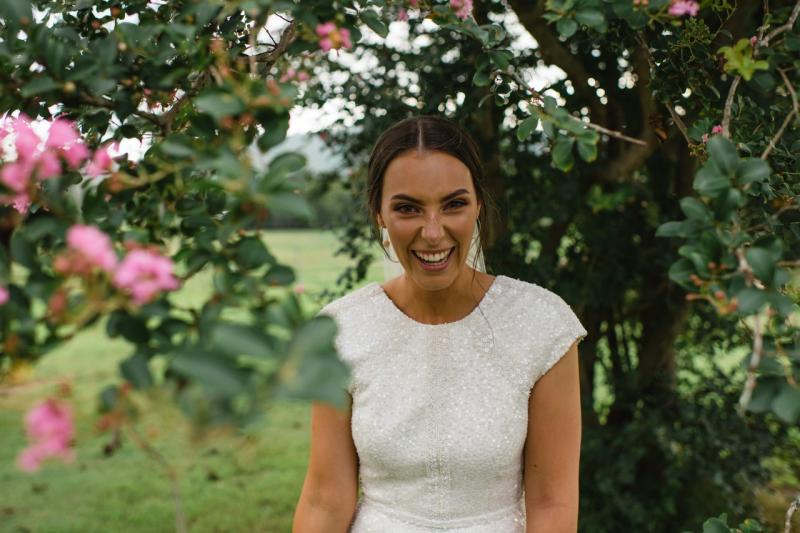 Real bride Elly wears the Annette wedding dress by Karen Willis Holmes; featuring cap sleeves with a high neck and low back.
