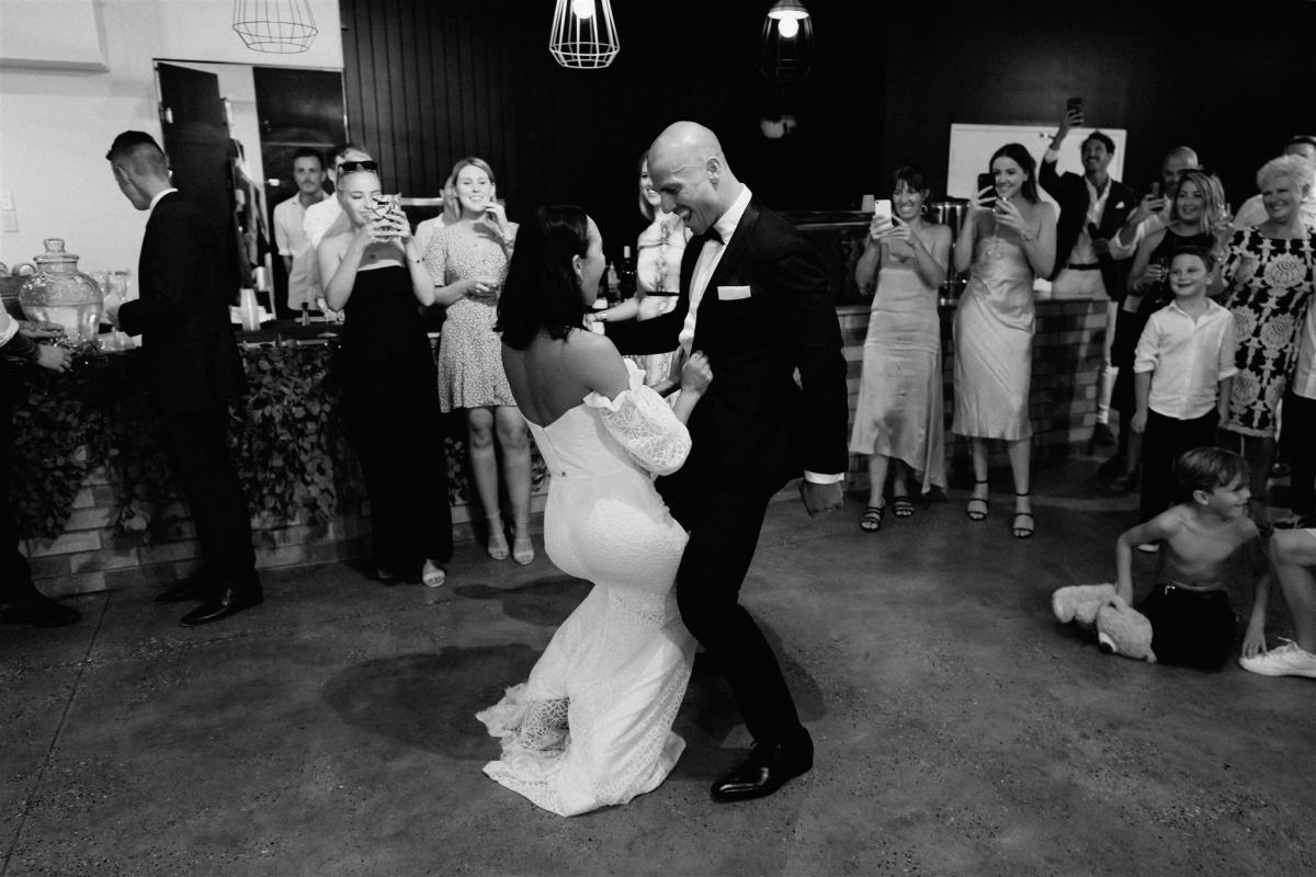 Bride wears Wild Hearts made to order lace off the shoulder Vivienne gown by Karen Willis Holmes dancing with husband at elegant reception