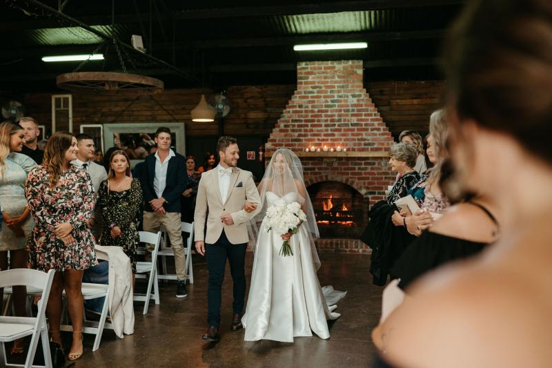 Real bride Brennah and Trent at the altar, bride wearing the Blake Camille Bespoke wedding dress by Karen Willis Holmes.