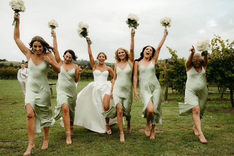 Real bride Brennah with her mint coloured bridesmaids; ladies holding white based bouquets