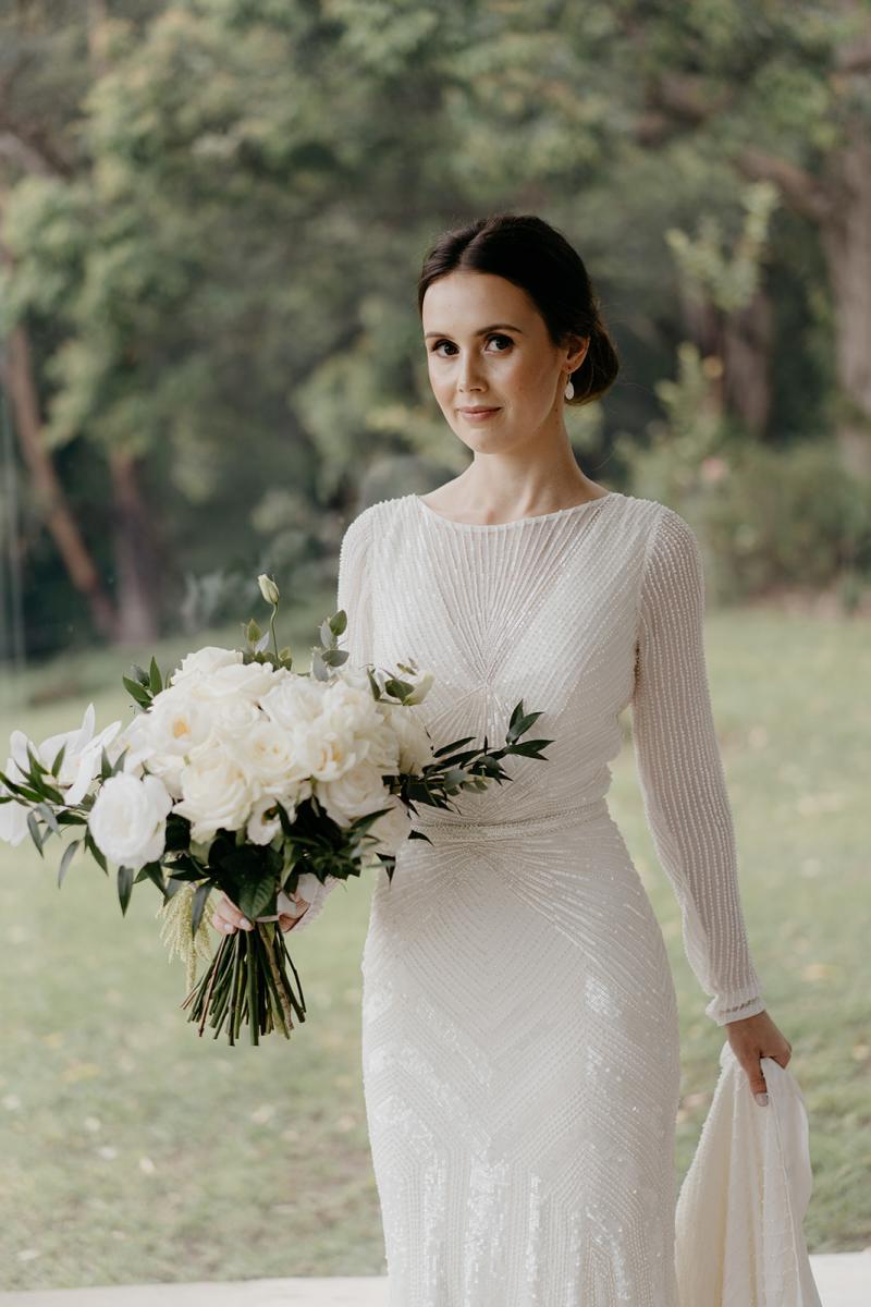 KWH bride Anna holding timeless bouquet wearing the art deco inspired Cassie wedding dress