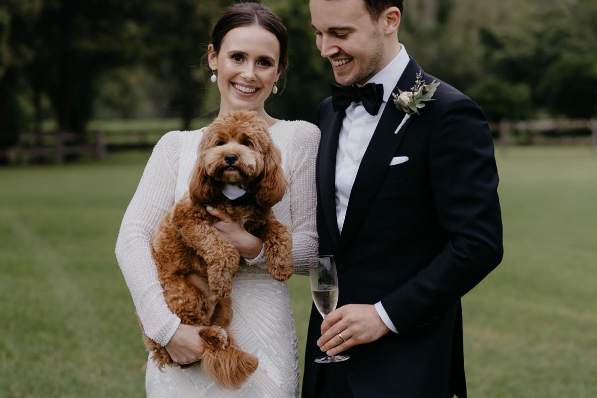 Karen Willis Holmes bride Anna and her husband Julian with their adorable dog. Anna wearing the Cassie wedding dress.