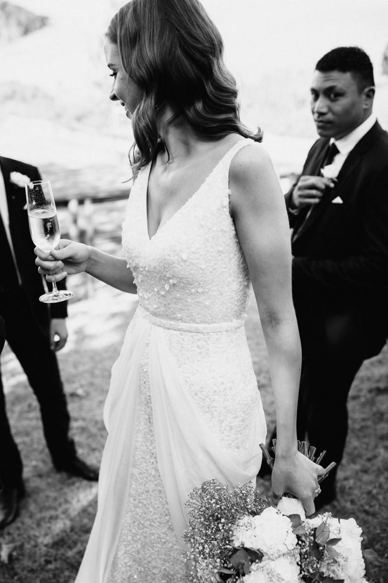 KWH real bride Tash looking in the mirror wearing our Lola gown with a low v-back.
