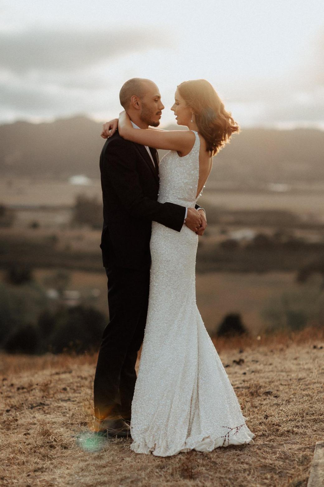 KWH bride Tash sharing intimate moment with husband Josh at sunset; wearing the Lola wedding dress.
