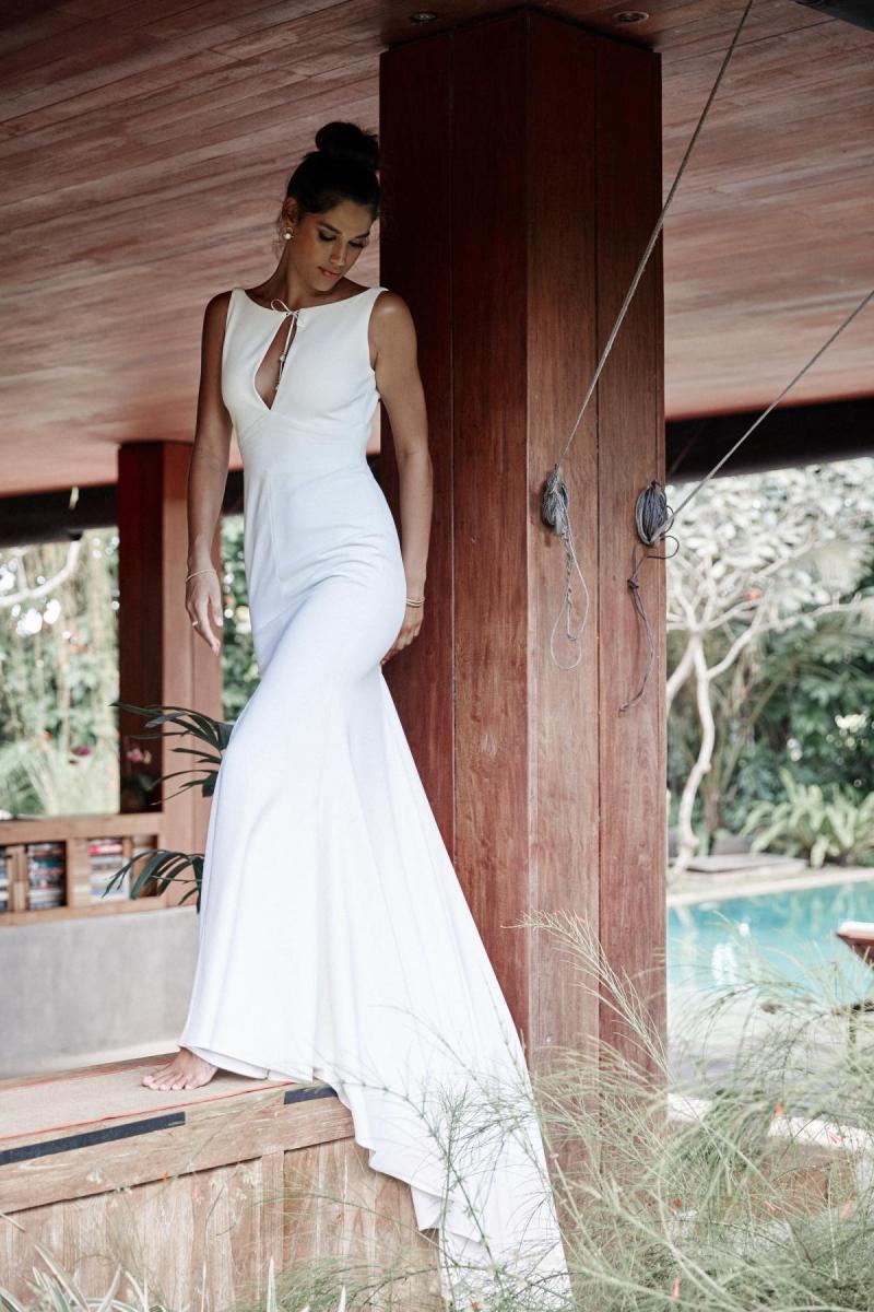 Model wears Ebony Fit and Flare wedding dress style silhouette in stretch crepe by Karen Willis Holmes