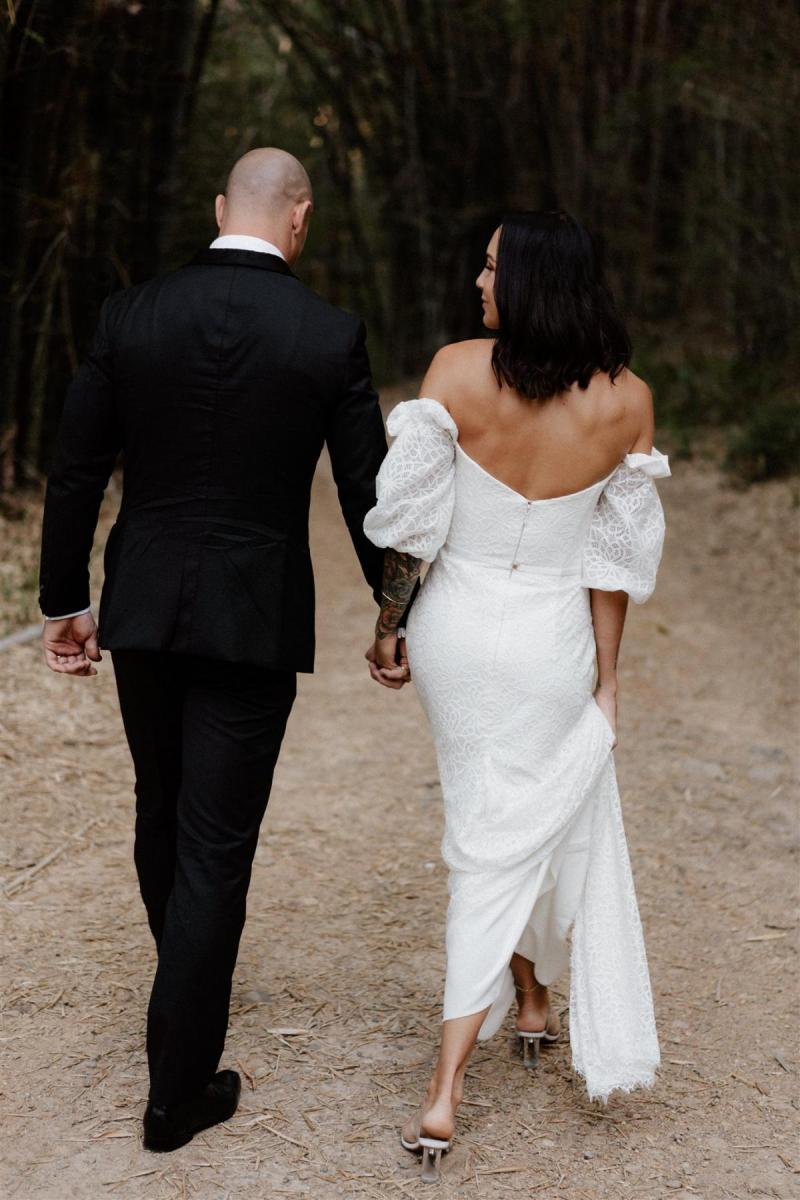 Real bride Lidia wears the Vivienne wedding dress, a lace wedding dress with balloon sleeves and dramatic train by Karen Willis Holmes for the boho bride