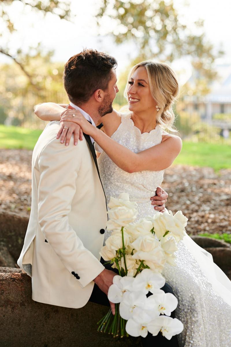 Real bride Claire wears the Cindy gown, a beaded halterneck wedding dress to her first look, Luxe dress by Karen Willis Holmes.