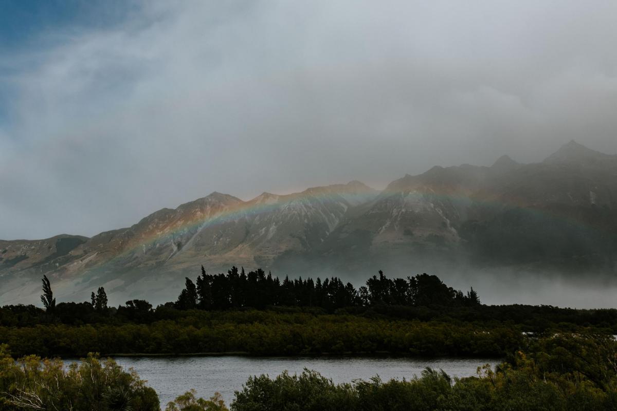 KWH bride Lauren's view from her New Zealand Ceremony with rainbow over the mountanous landscape.