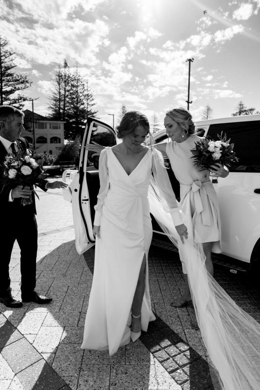 Real bride Shannon arriving to her church wedding, wearing the timeless Nikki wedding dress from the Wild Hearts Collection.