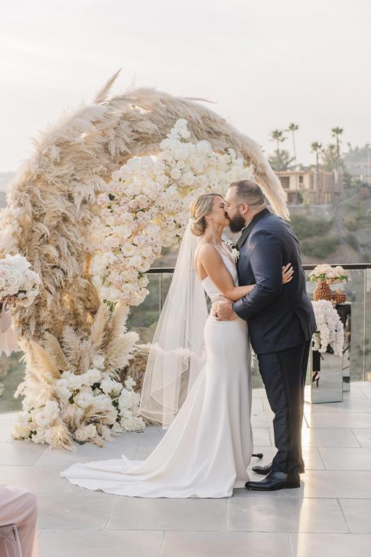 Real bride Noel wears the Caroline gown; a simple v-neck wedding dress from the Wild Hearts collection by Karen Willis Holmes to her intimate LA wedding.