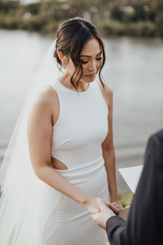 Real bride Melissa wears the Bridget gown to beach wedding, a relaxed casual halter wedding dress by Karen Willis holmes, paired with the KWH Claude Veil; a minimalists bridal veil.