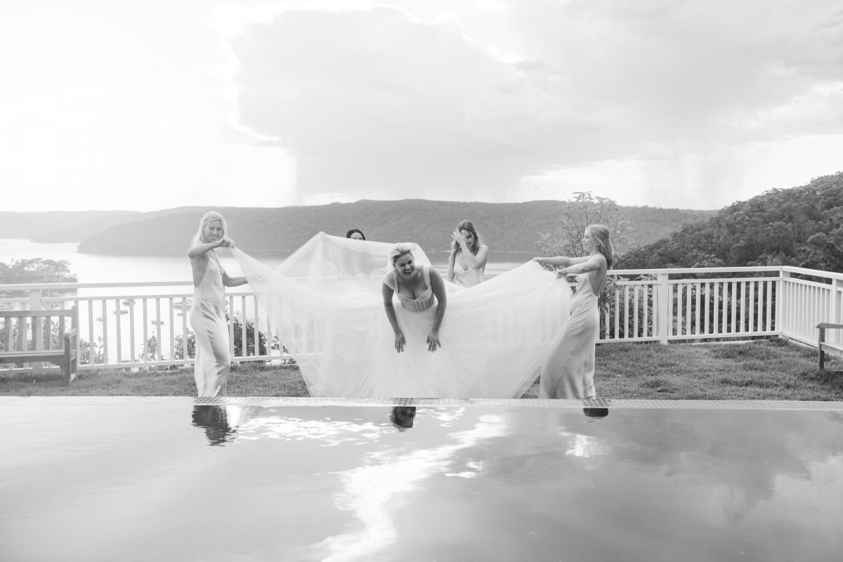 Real bride Arabella with her bridesmaids at small covid wedding, wearing the Audrey gown by Karen Willis Holmes.