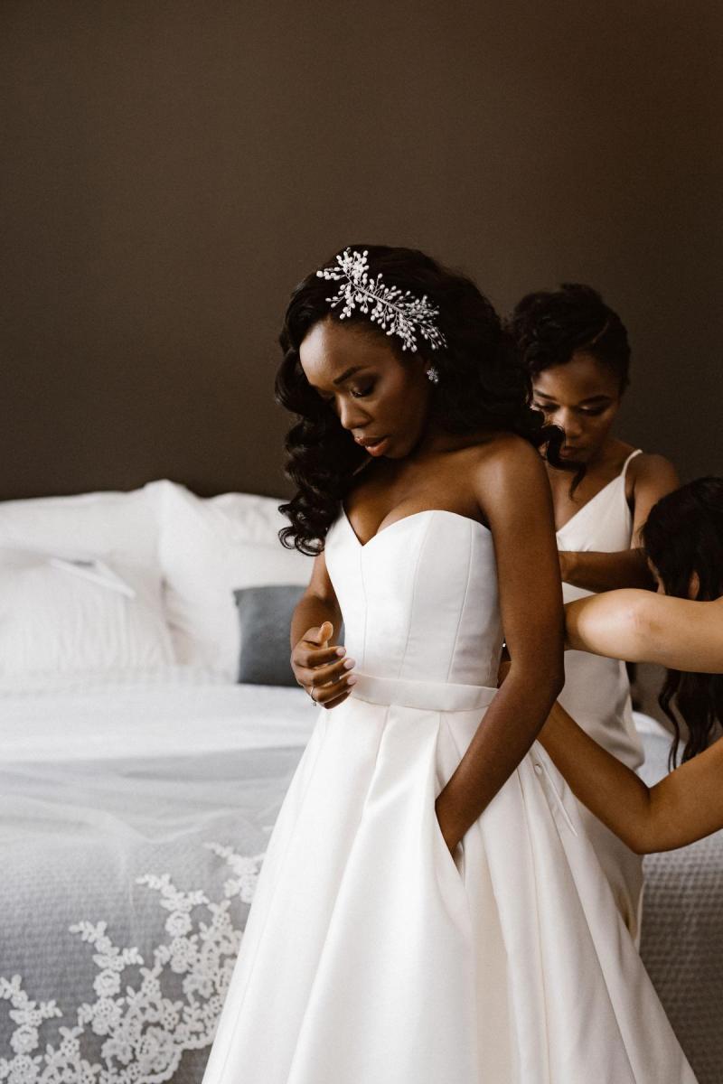 Real bride Ancille getting ready for her church wedding, wearing the Kitty Melanie gown by Karen Willis Holmes with sweetheart neckline.