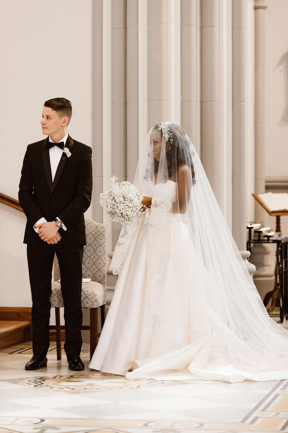Real bride Ancille at church altar, wearing the Kitty Melanie gown; an aline traditional style wedding dress by Karen Willis Holmes with a Steven Khalil veil.
