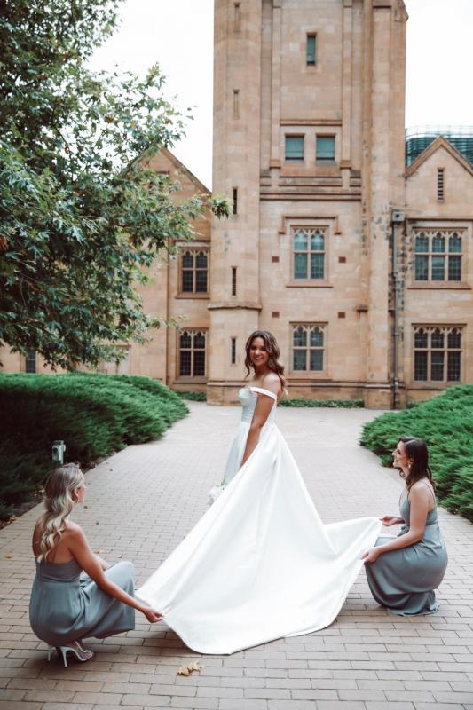 Real bride Valentina poses with bridesmaids, showing off the dramatic train of her Blake Camille gown; a traditional sweetheart neckline wedding dress by Karen Willis Holmes.