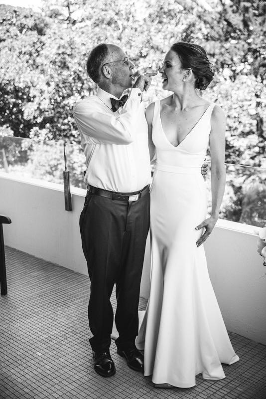 Real bride Joan with her father on the day of her wedding, wearing the Imogen gown; a chic simple v-neck wedding dress by Karen Willis holmes.