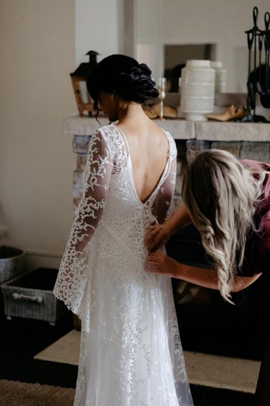Real bride Saliya getting ready for her garden wedding, wearing the Pascale gown; a nontraditional lace wedding dress by Karen Willis Holmes.