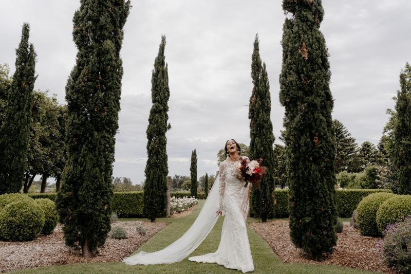 Real bride Saliya wearing the Pascale gown; a long sleeve nontraditional lace wedding dress by Karen Willis Holmes.