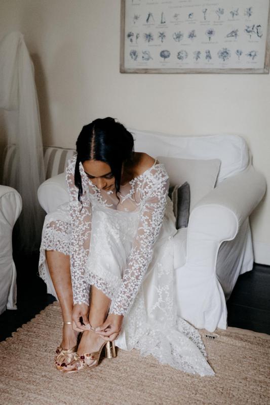 Real bride Saliya getting ready for her garden wedding, wearing the Pascale gown; a nontraditional lace wedding dress by Karen Willis Holmes.