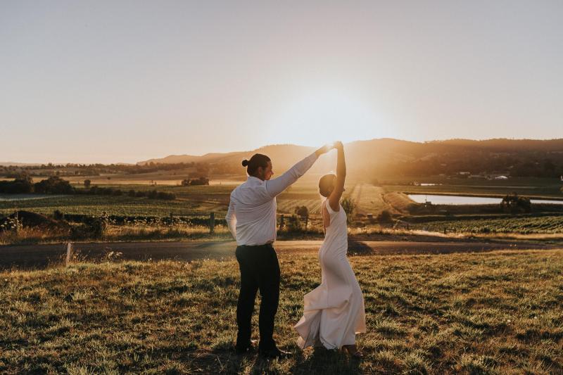 KWH bride Kate and Mik dance in front of the glowing sunset. Her Arabella gown by KWH twist as as she moves.