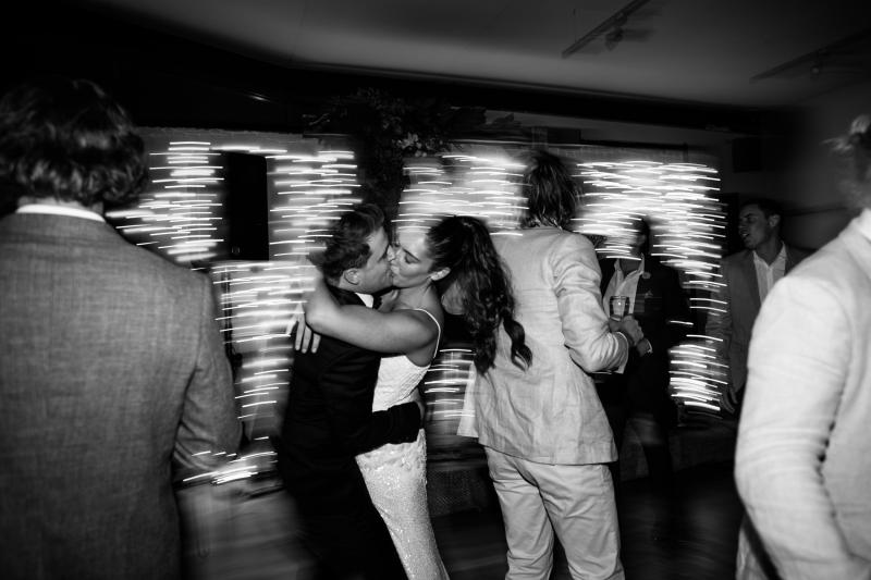 Real bride Ruby dances the night away in her Darcy gown by Karen Willis Holmes, while also hugging her new husband.