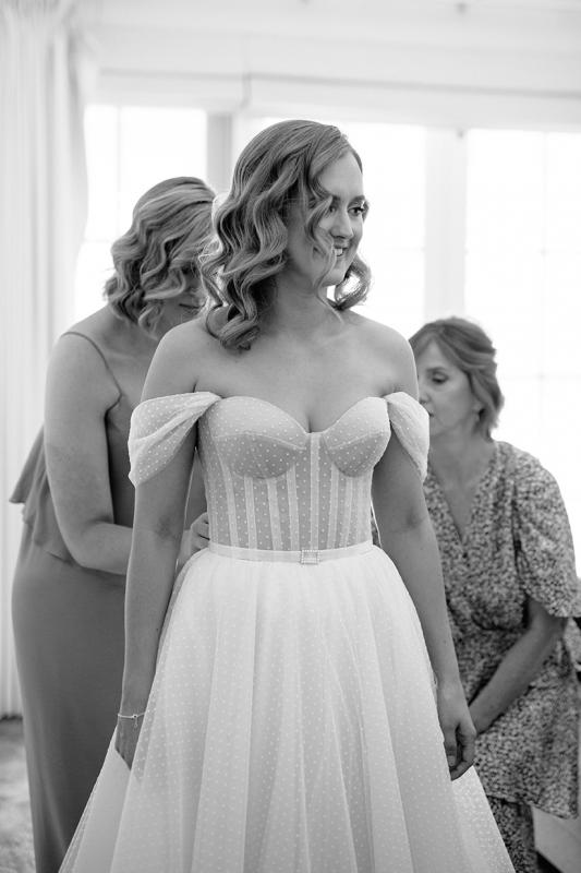 Real bride Jess getting ready for her wedding, wearing the Audrey gown; a polka dot wedding dress by Karen Willis Holmes.