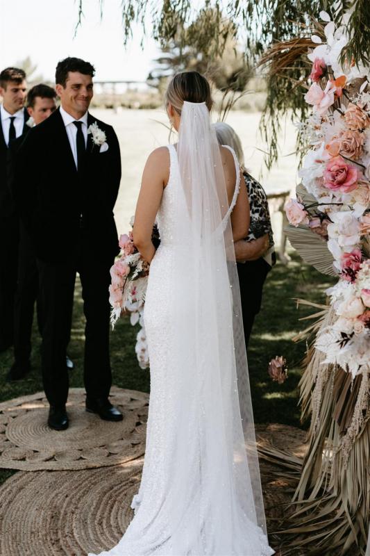 Real bride Bre at her Melbourne wedding ceremony, wearing the Lola gown; a beaded fit n flare wedding dress by Karen Willis Holmes.
