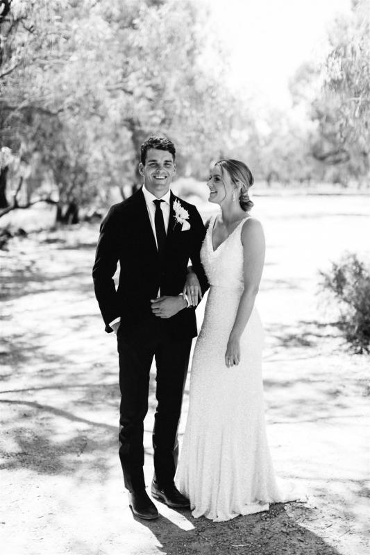Real bride Bre with her husband Ted at their Melbourne wedding, wearing the Lola gown; a beaded fit n flare wedding dress by Karen Willis Holmes.