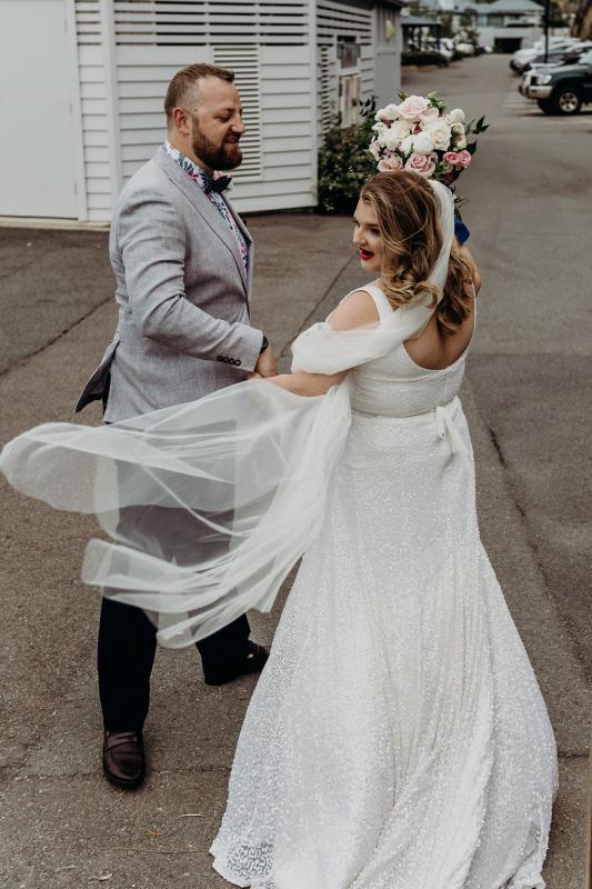 Real bride Annabel with her new husband ryan, wearing the Lotus gown and Camila Veil; a sequin a-line wedding dress by Karen Willis Holmes.