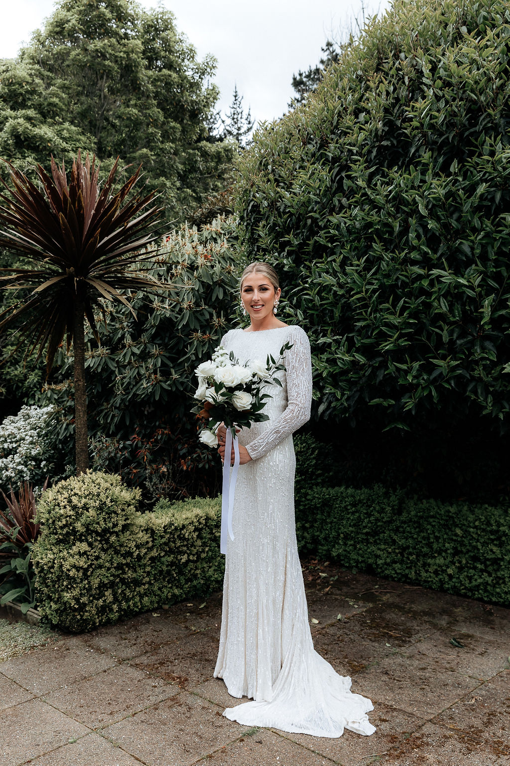 Real bride Hannah stands with her This Plus That white bouquet and sequined Maragerta gown by Karen Willis Holmes.