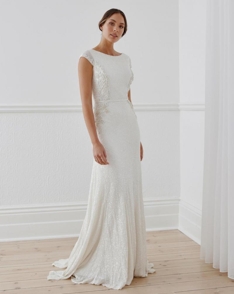 The Rosabell gown by Karen Willis Holmes, a cap sleeve beaded wedding dress with a fit and flare shape.
