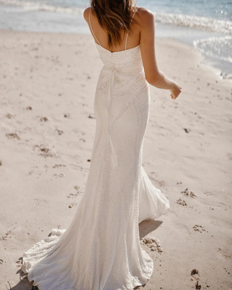 The Isabelle gown by Karen Willis Holmes, a unique spaghetti strap beaded wedding dress with a fit and flare shape.