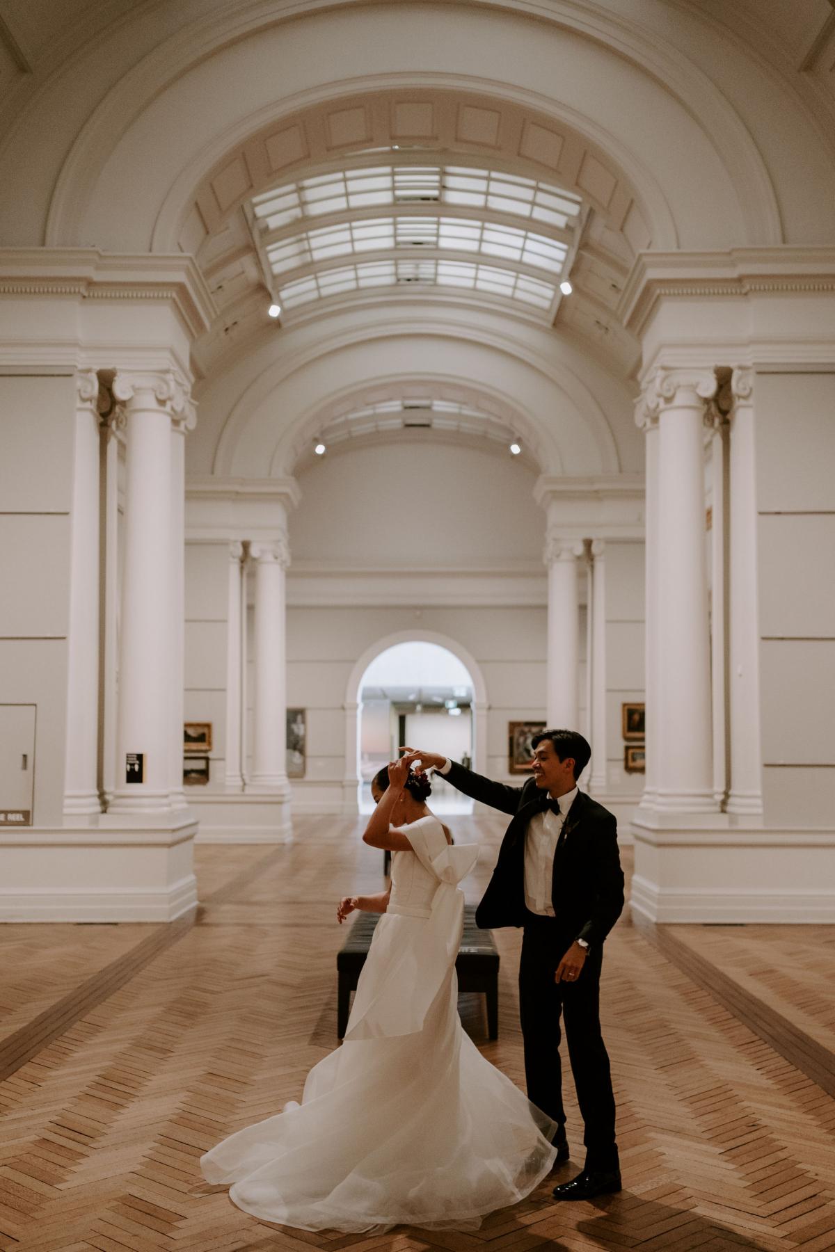 Brian gives KWH real bride Sarah a twirl in the main gallery hall. She wears the effortless Kitty Joni gown.