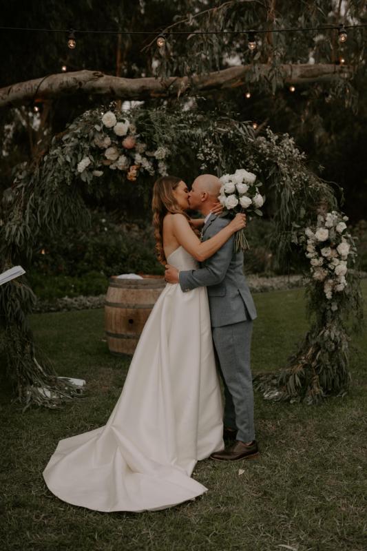KWH real bride Elke kisses Kyle in her bespoke Blake Camille wedding dress made from twill.