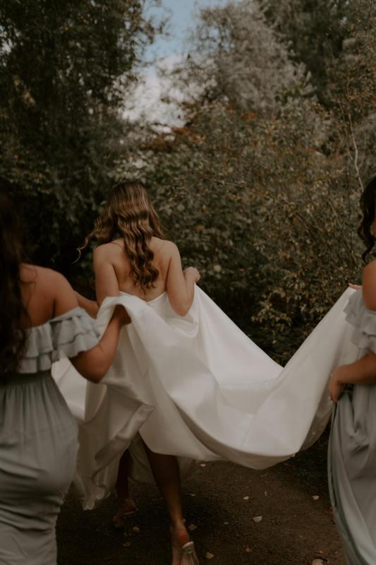 KWH real bride Elke has her bridesmaids carry her Blake Camille train. This is a modern twill gown with long train