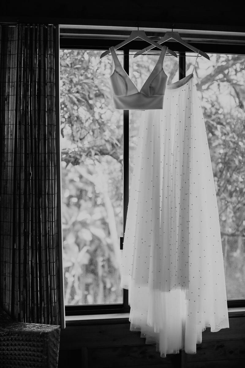 B&W image of KWH real bride Jana's Erin and Lea bridal set hanging in the window.