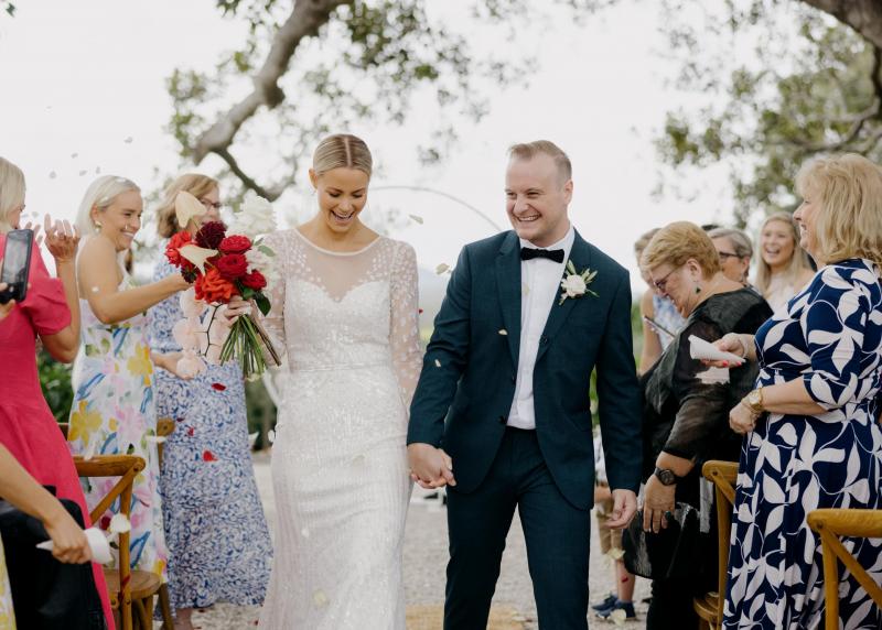 KWH real bride Taylor and Kalen walk down the aisle as she wears the sweetheart cut Lexie gown